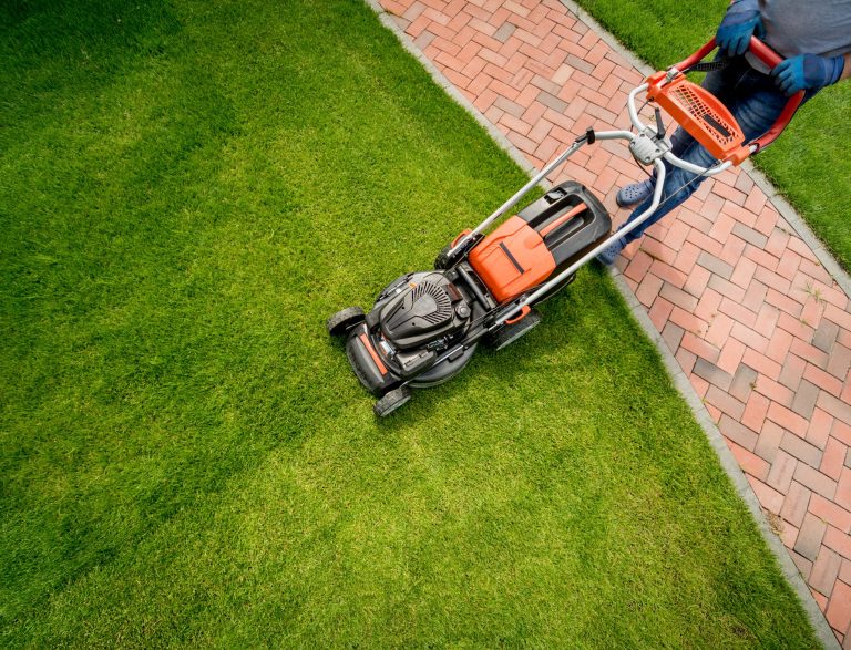 gardener-mowing-lawn-landscape-design-scaled